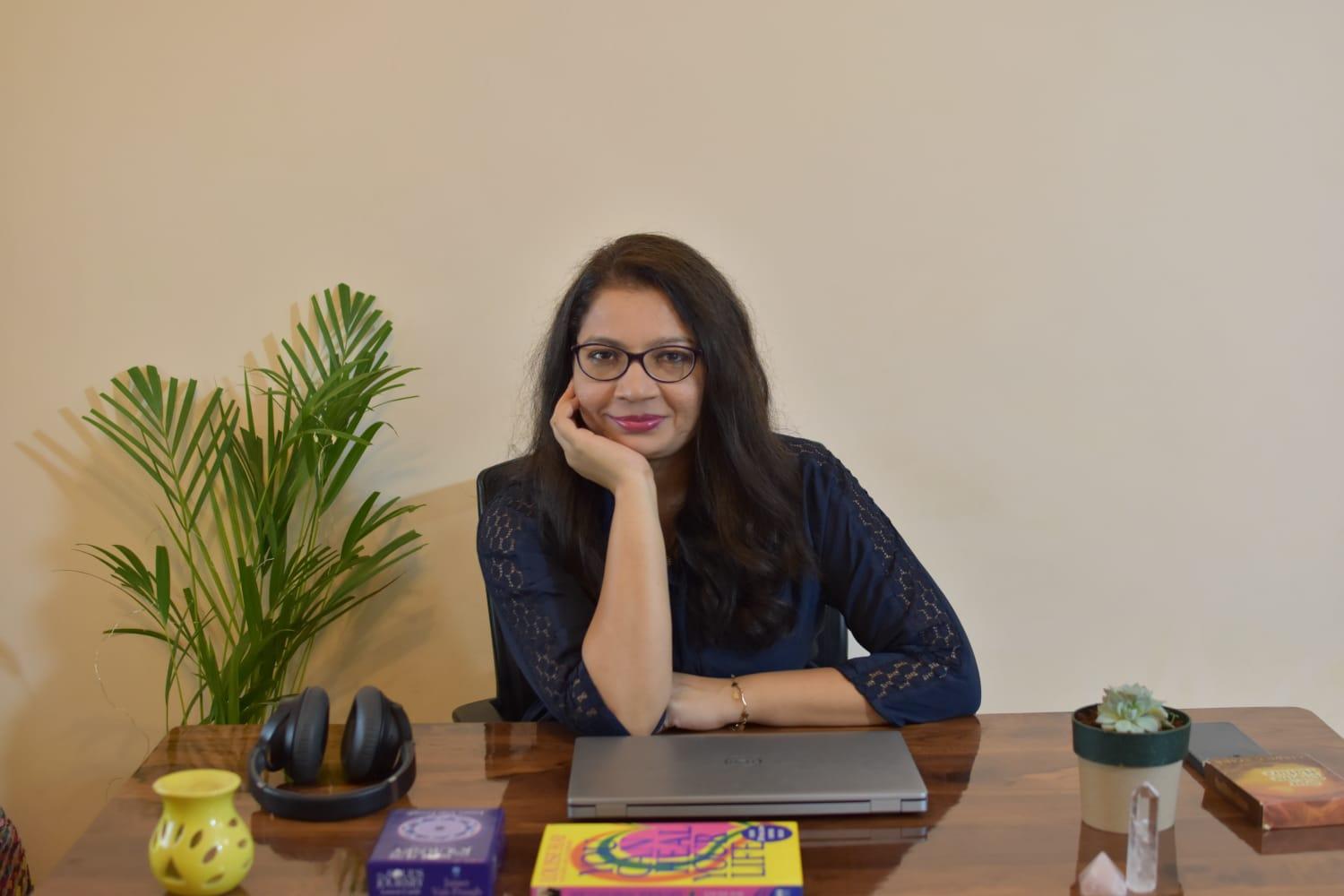 Woman sitting calmly in soft natural light, creating a warm and safe healing space