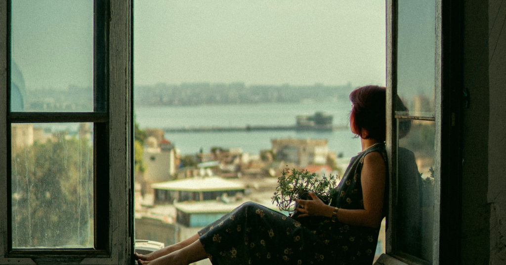 image of woman sitting and reflecting on overthinking and unprocessed emotions